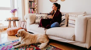 woman relaxing on sofa with dog